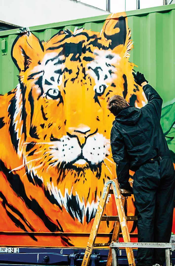 Noah s train for our planet Since mid-december, an unusual freight train has been crossing Europe carrying containers spray-painted with large-scale, colourful animal motifs.